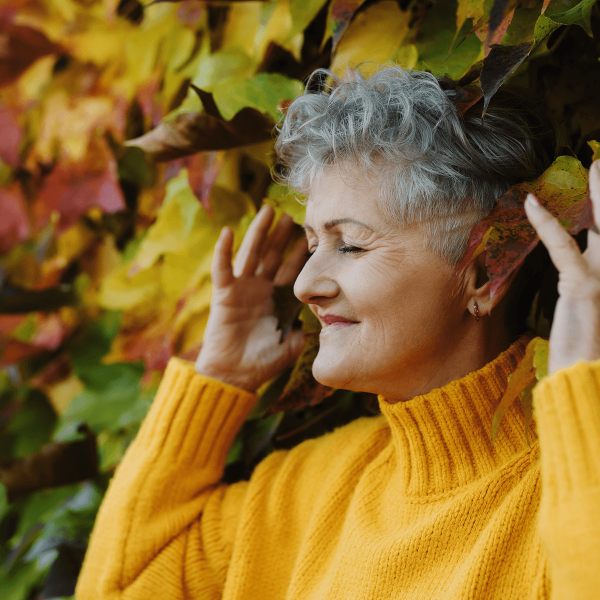 Femme écoutant la nature au bord d'une haie